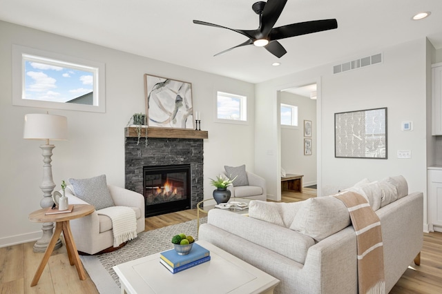 living area with visible vents, recessed lighting, light wood-style floors, a fireplace, and baseboards