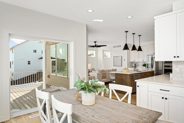 dining room featuring a ceiling fan, light wood-style flooring, recessed lighting, and visible vents