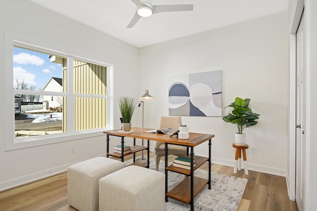 home office with ceiling fan, baseboards, and wood finished floors