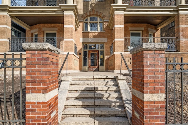 property entrance with brick siding and fence