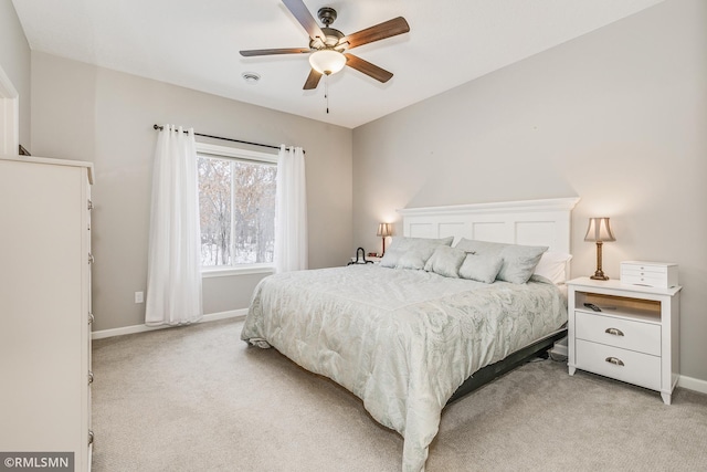 bedroom featuring light carpet, ceiling fan, and baseboards