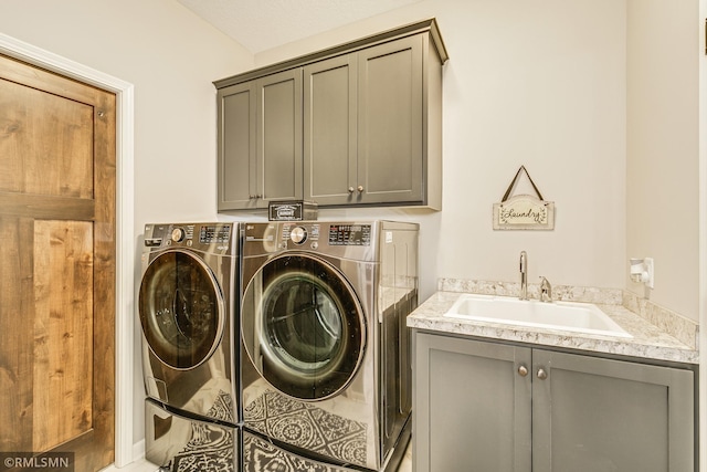 laundry room featuring independent washer and dryer, a sink, and cabinet space