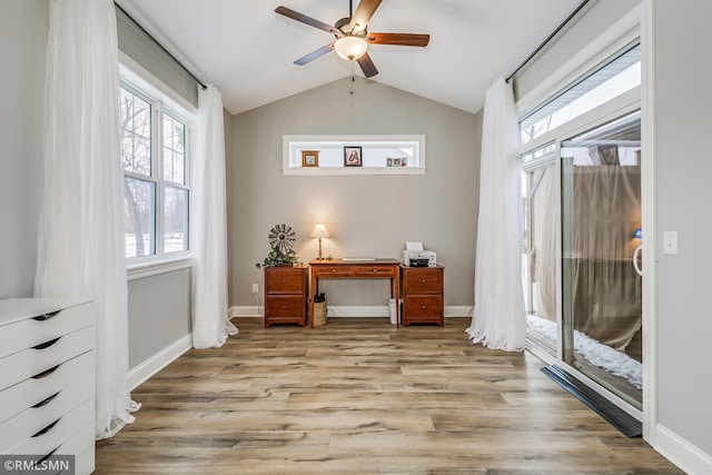 office with lofted ceiling, ceiling fan, baseboards, and light wood-style floors