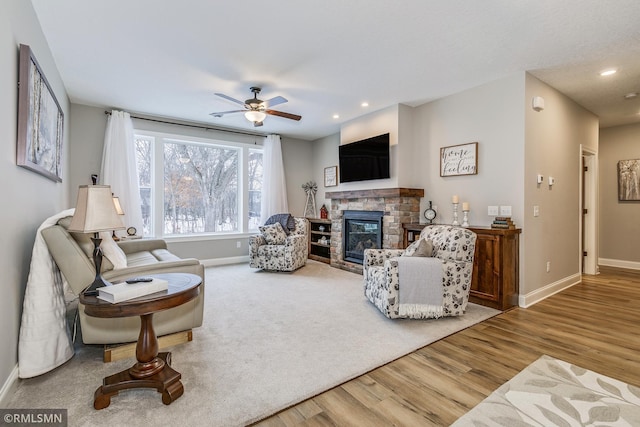 living area featuring a fireplace, baseboards, wood finished floors, and recessed lighting