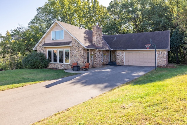 view of front of house with brick siding, a chimney, a garage, driveway, and a front lawn