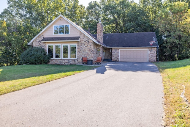 view of front of home with a front lawn, brick siding, a chimney, and an attached garage