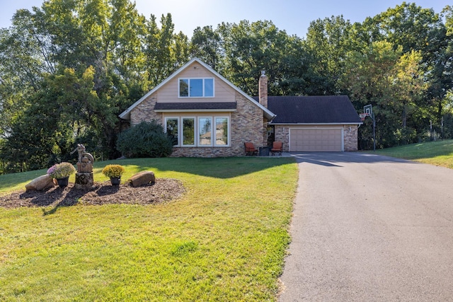 view of front of house featuring a garage, a front lawn, a chimney, and aphalt driveway