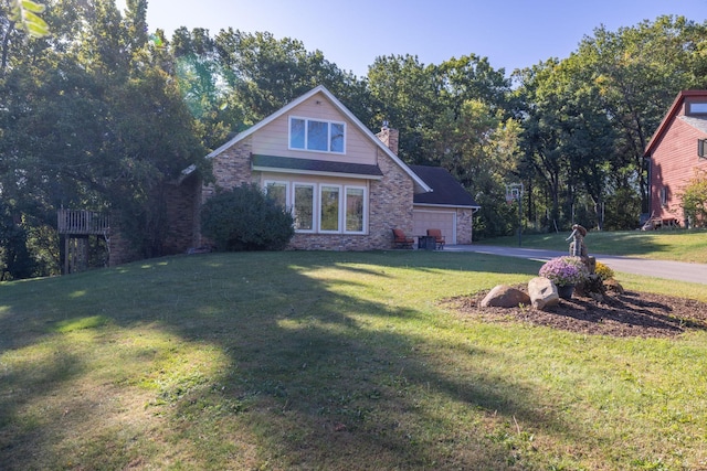 view of front facade with a garage, driveway, a chimney, and a front yard