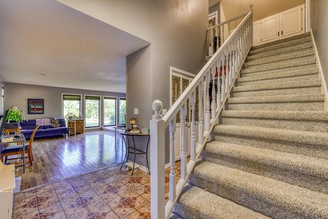 stairs with baseboards and wood finished floors