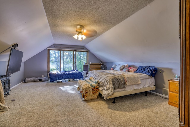 carpeted bedroom featuring visible vents, baseboards, ceiling fan, vaulted ceiling, and a textured ceiling