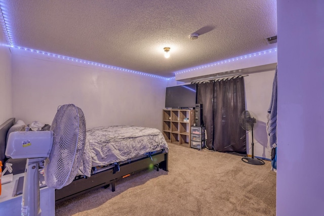 carpeted bedroom featuring a textured ceiling