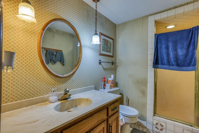 full bathroom with a textured ceiling, vanity, toilet, and wallpapered walls