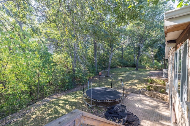 71 Deer Hills Ct, North Oaks, MN 55127 - wooden terrace with a trampoline and a lawn