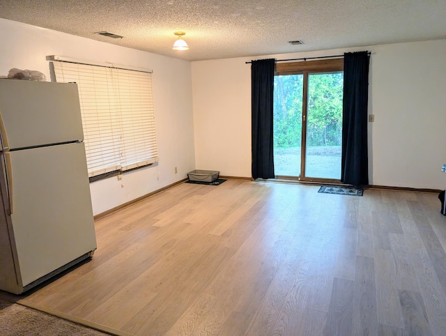 71 Deer Hills Ct, North Oaks, MN 55127 - unfurnished room with light wood-style flooring, a textured ceiling, and baseboards