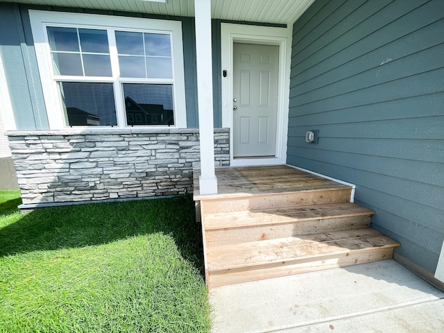 doorway to property with stone siding