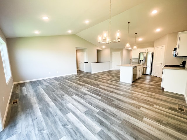 kitchen featuring white cabinets, visible vents, appliances with stainless steel finishes, and open floor plan