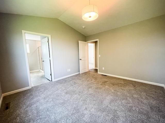 unfurnished bedroom featuring lofted ceiling, carpet, visible vents, and baseboards