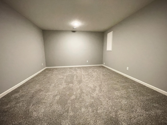 carpeted spare room with baseboards