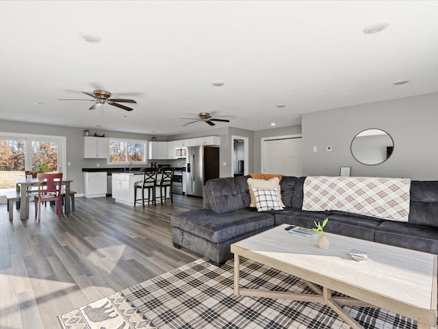 living room with ceiling fan and wood finished floors