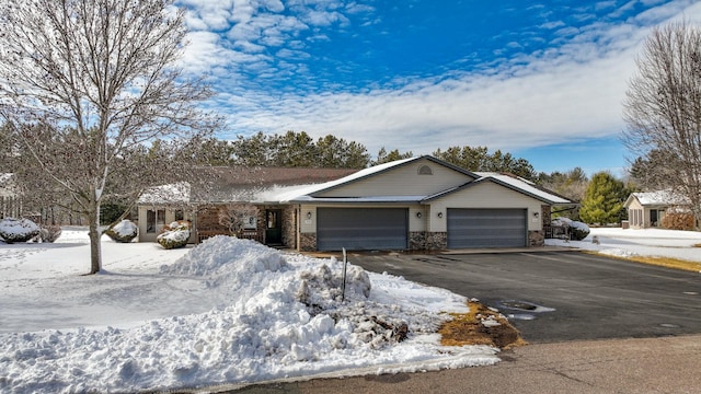 ranch-style house with a garage, driveway, and brick siding