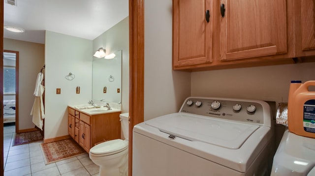 laundry room with laundry area, light tile patterned flooring, a sink, and washer and dryer