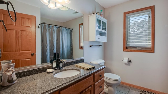 full bath featuring curtained shower, toilet, vanity, tile patterned flooring, and baseboards