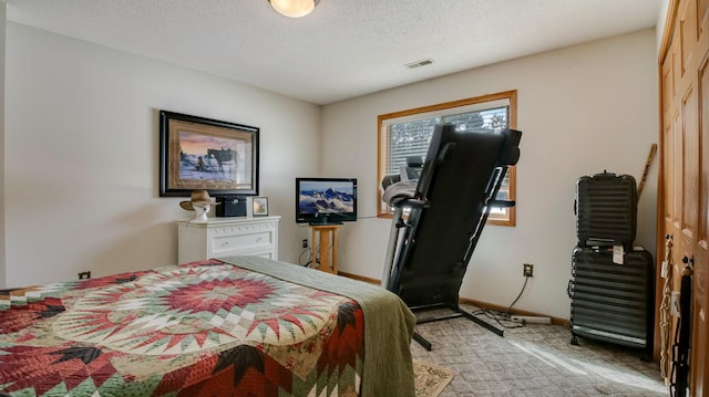 bedroom featuring light colored carpet, visible vents, a textured ceiling, and baseboards