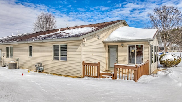 snow covered property featuring cooling unit