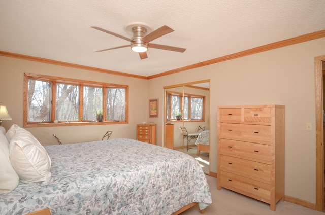 bedroom featuring light colored carpet, a textured ceiling, crown molding, and baseboards