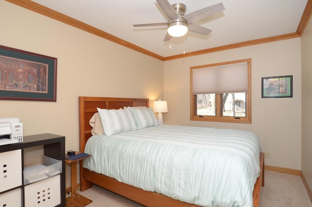 carpeted bedroom with crown molding, baseboards, and ceiling fan