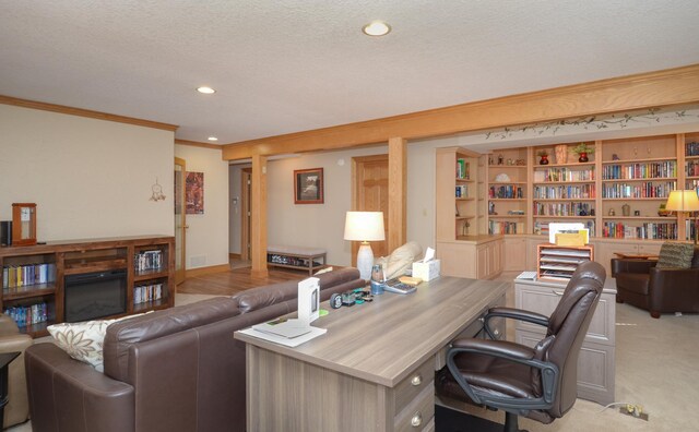 office space with a textured ceiling, baseboards, recessed lighting, ornamental molding, and light carpet