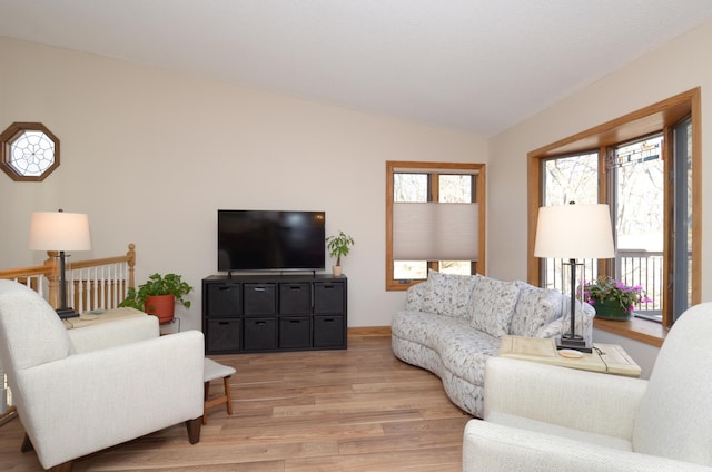 living room with light wood-style floors and lofted ceiling