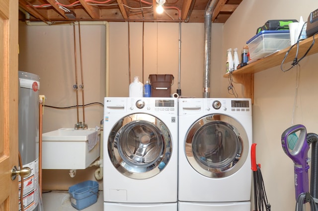 laundry room featuring a sink, separate washer and dryer, water heater, and laundry area