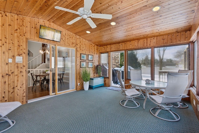 sunroom / solarium featuring wooden ceiling, a ceiling fan, and vaulted ceiling