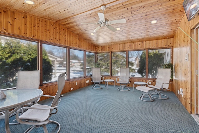 sunroom with vaulted ceiling, wood ceiling, and ceiling fan