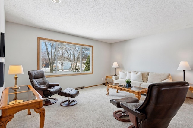 living area featuring visible vents, baseboards, a textured ceiling, and carpet flooring