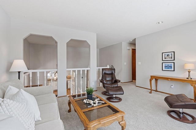 carpeted living area with baseboards