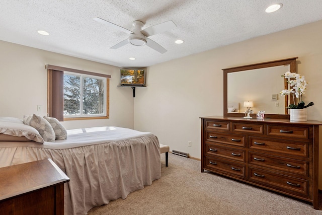 bedroom featuring recessed lighting, visible vents, light colored carpet, and a textured ceiling