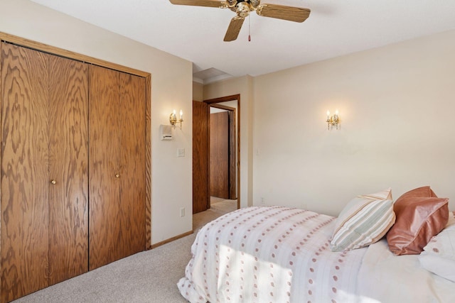 carpeted bedroom featuring baseboards, a closet, and ceiling fan