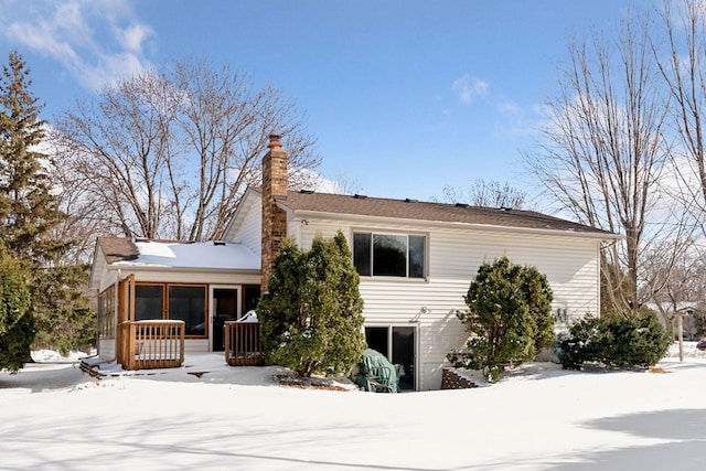 exterior space featuring a sunroom and a chimney