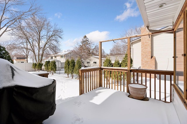 snow covered deck with a residential view