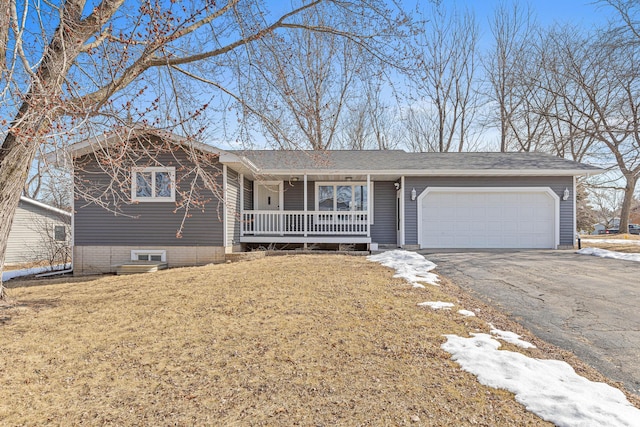 ranch-style home with aphalt driveway, a garage, a porch, and a front lawn