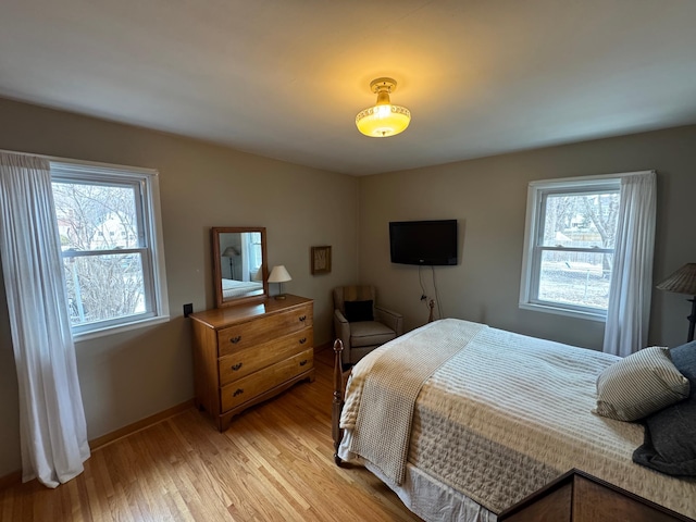 bedroom featuring baseboards and light wood-style floors