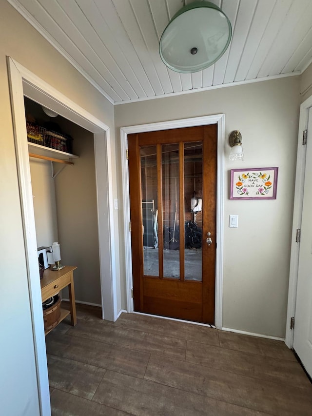 interior space with wooden ceiling, baseboards, ornamental molding, and wood finished floors