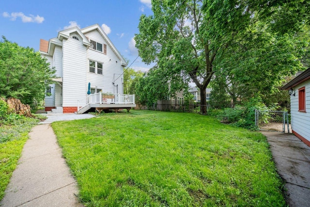 view of yard featuring fence and a wooden deck