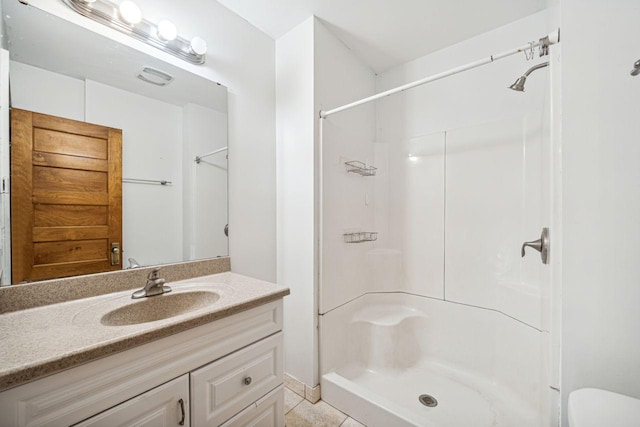 full bath featuring toilet, a stall shower, and vanity