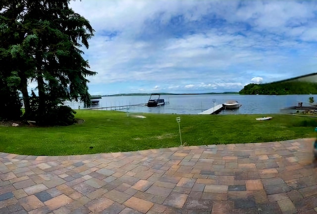 view of patio featuring a water view and a boat dock