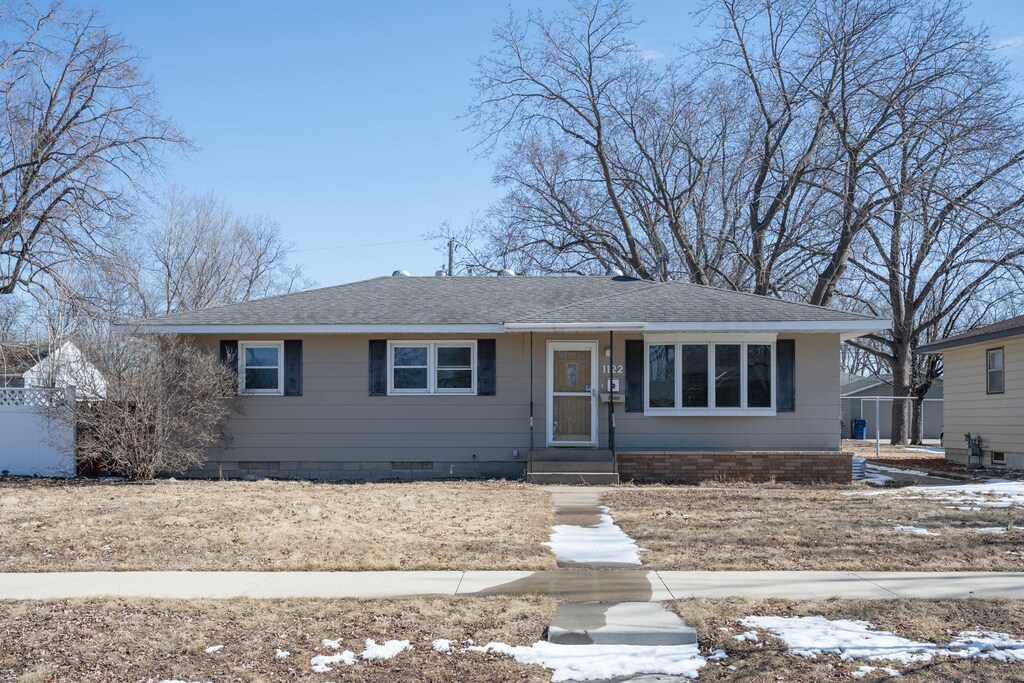 view of front of home featuring roof with shingles and crawl space