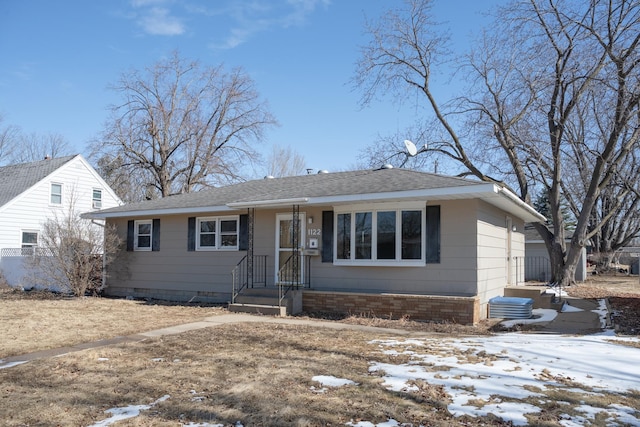 view of front of home featuring a shingled roof and crawl space