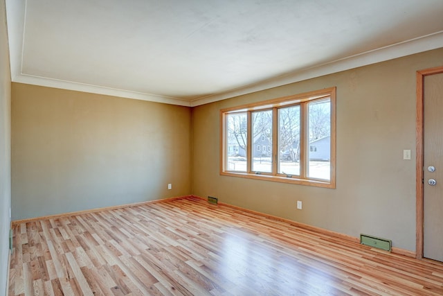 empty room featuring visible vents and wood finished floors